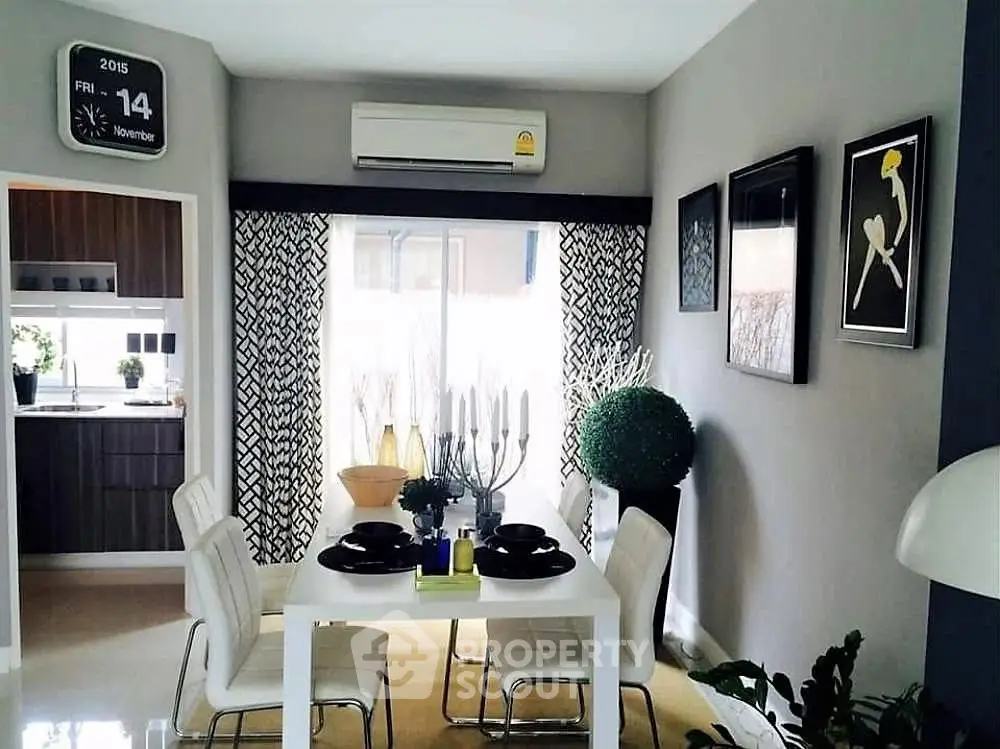 Modern dining area with stylish decor and open kitchen layout, perfect for contemporary living.