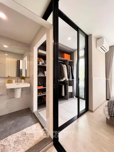 Modern bedroom with walk-in closet and sleek bathroom design