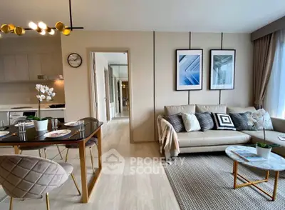 Modern living room with stylish decor and open kitchen layout in a contemporary apartment.