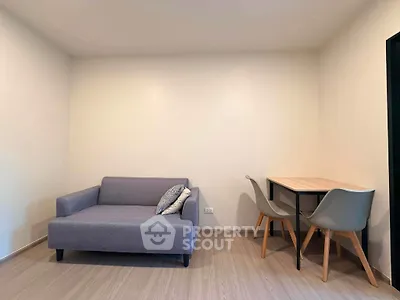 Modern minimalist living room with cozy sofa and dining table set.