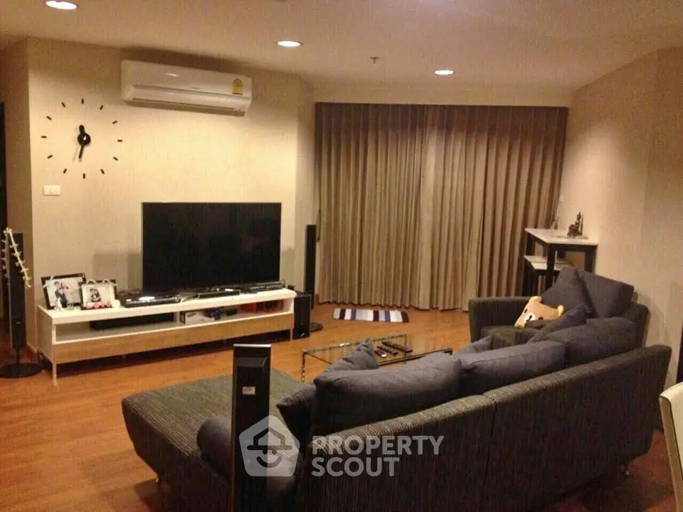 Cozy living room with modern furniture and entertainment setup, perfect for relaxation and gatherings.