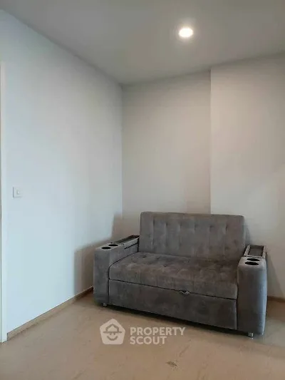 Cozy living room with modern gray sofa and minimalist design.