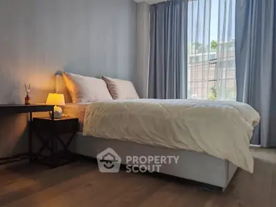 Elegant bedroom with cozy lighting and large window view