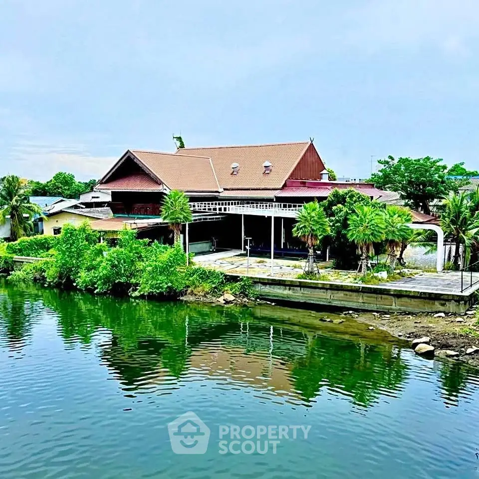 Stunning waterfront property with lush greenery and serene views.