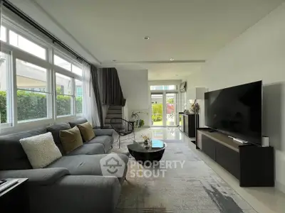 Spacious modern living room with large windows and stylish decor