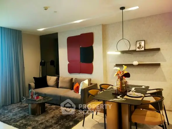 Modern living room with stylish decor and dining area, featuring contemporary furniture and elegant lighting.