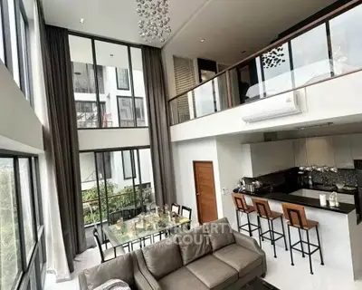 Luxurious modern living room with high ceilings and open kitchen layout