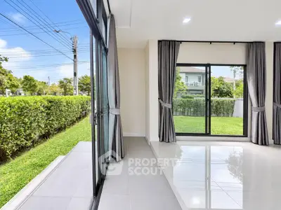 Spacious modern living room with large windows and garden view