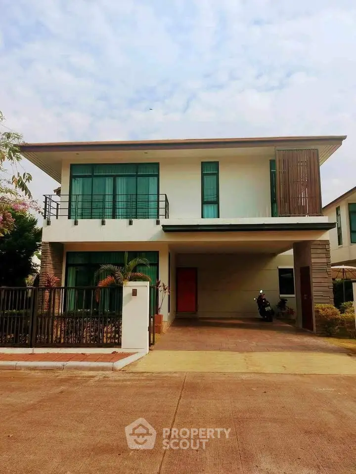 Modern two-story house with spacious driveway and contemporary design.