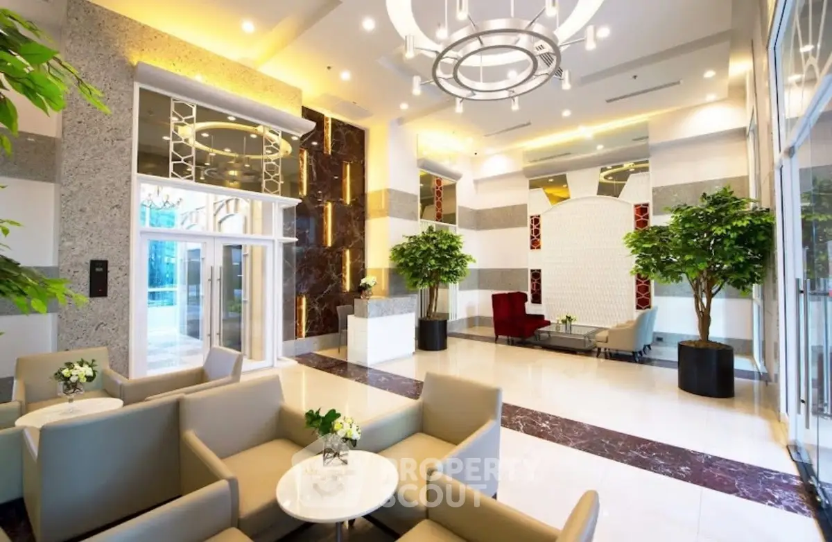 Luxurious modern lobby with elegant seating and stylish lighting in a high-end residential building.