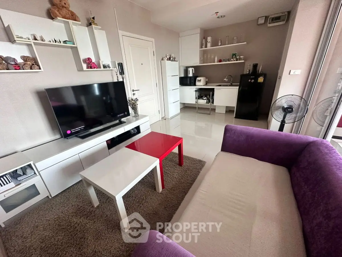 Modern living room with cozy sofa and sleek kitchen area