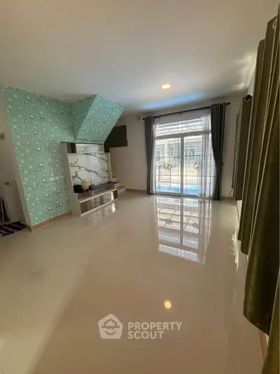 Spacious living room with modern decor and large windows for natural light.