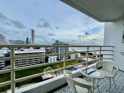 Stunning balcony view overlooking cityscape and ocean, perfect for relaxation.