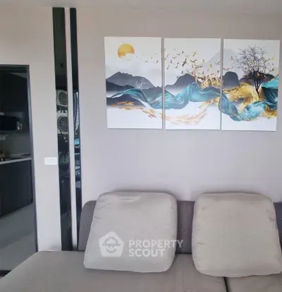 Modern living room with stylish wall art and cozy seating area.