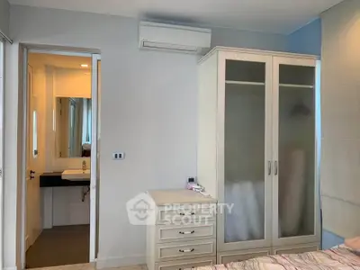 Modern bedroom with ensuite bathroom and sleek wardrobe design