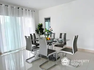 Modern dining room with sleek glass table and stylish chairs in bright interior