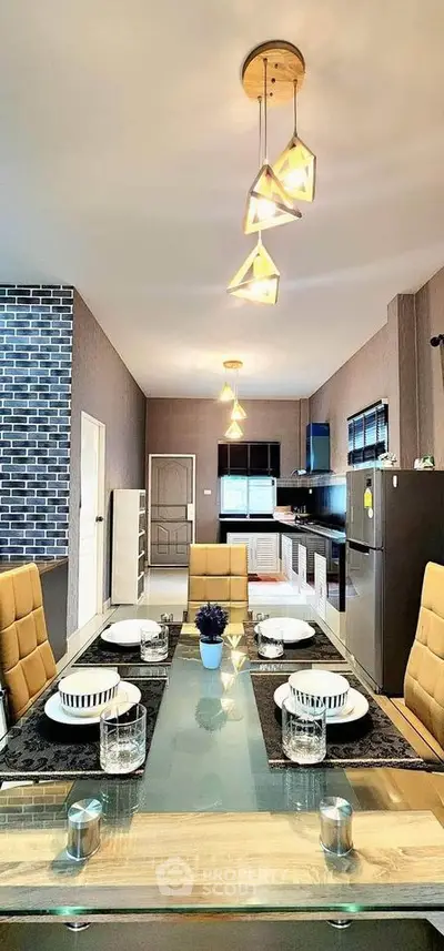 Modern kitchen with stylish lighting and glass dining table