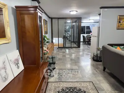 Spacious living room with elegant decor and open layout leading to dining area.
