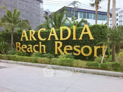 Arcadia Beach Resort entrance with lush greenery and modern architecture.