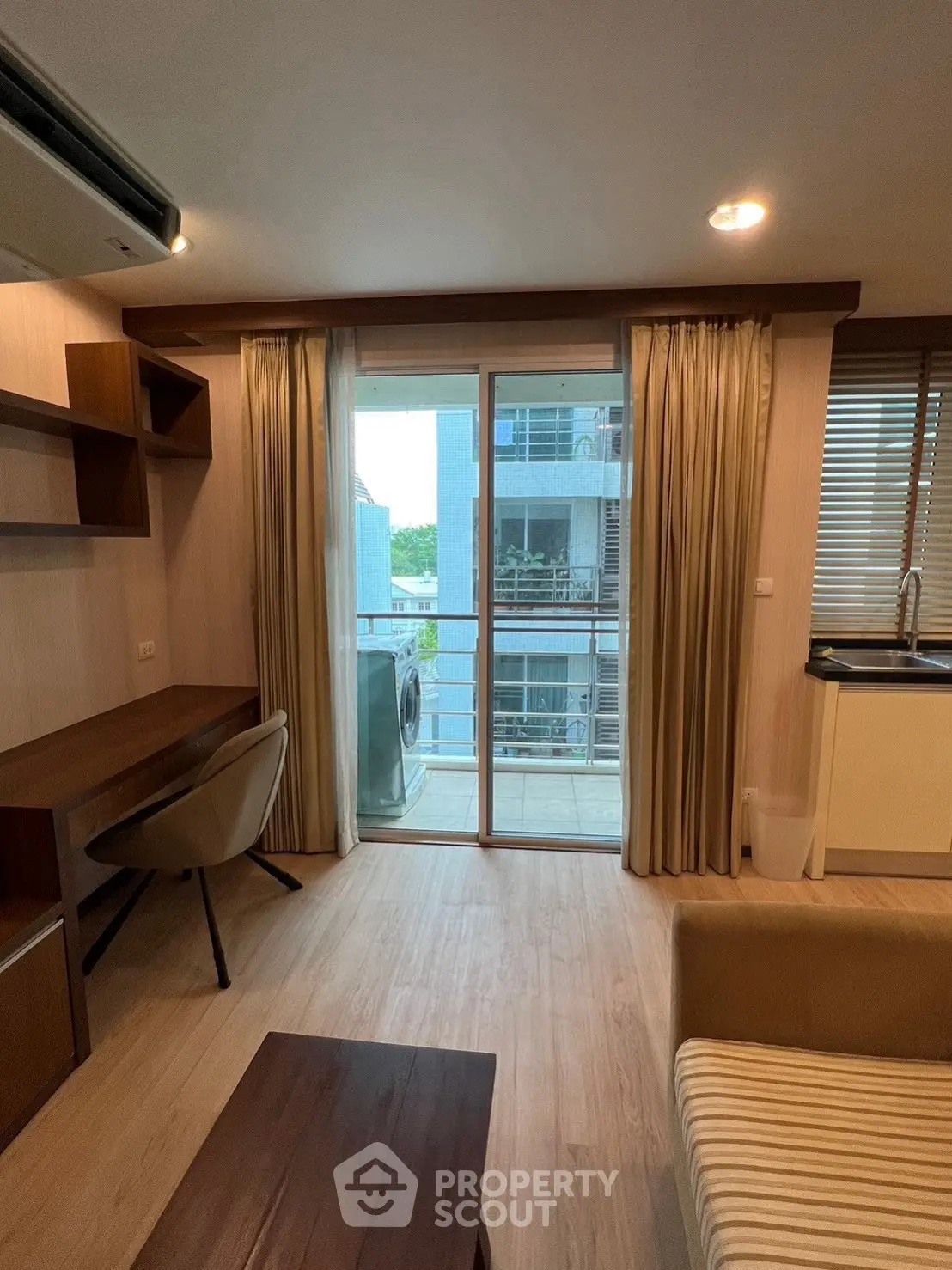 Modern living room with balcony and study area in a stylish apartment