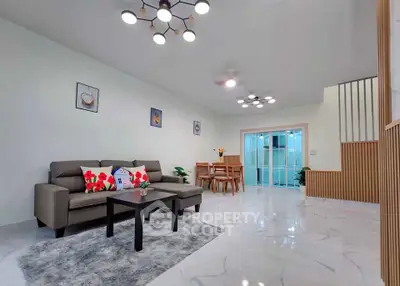 Spacious modern living room with stylish decor and open dining area, perfect for family gatherings.