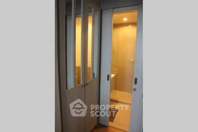 Modern bathroom with sliding doors and elegant lighting