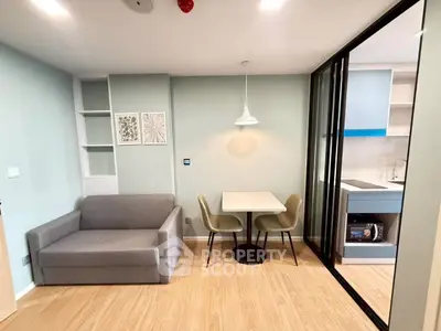 Modern living room with cozy sofa, dining area, and open kitchen layout in stylish apartment.