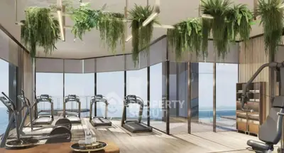 Luxurious gym with panoramic views and modern equipment in high-end residential building.