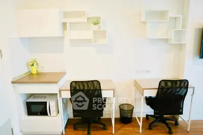 Modern study area with dual desks and shelving in a bright apartment.