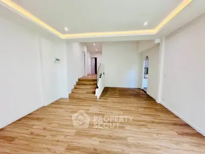 Spacious modern living room with wooden flooring and recessed lighting