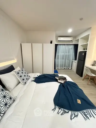 Modern bedroom with stylish decor and cozy ambiance, featuring a comfortable bed and sleek furnishings.