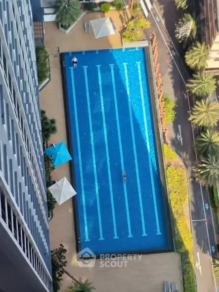 Stunning aerial view of a luxurious swimming pool in a modern residential complex.