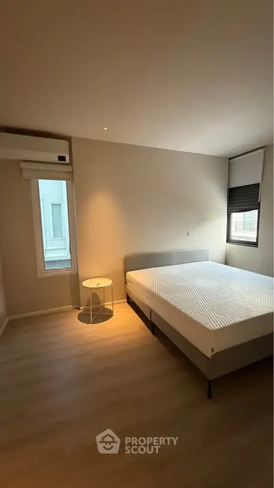 Modern minimalist bedroom with natural light and stylish decor