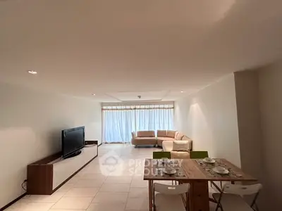 Spacious living room with modern furniture and large windows for natural light.