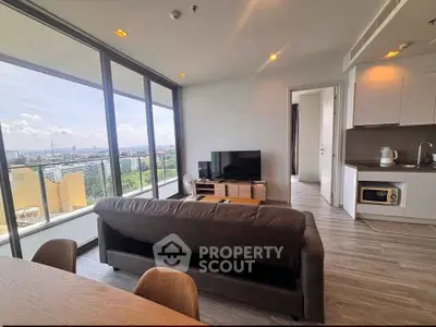 Modern living room with panoramic city view and open kitchen layout