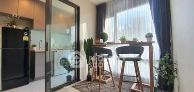 Modern kitchen with washing machine and stylish dining area