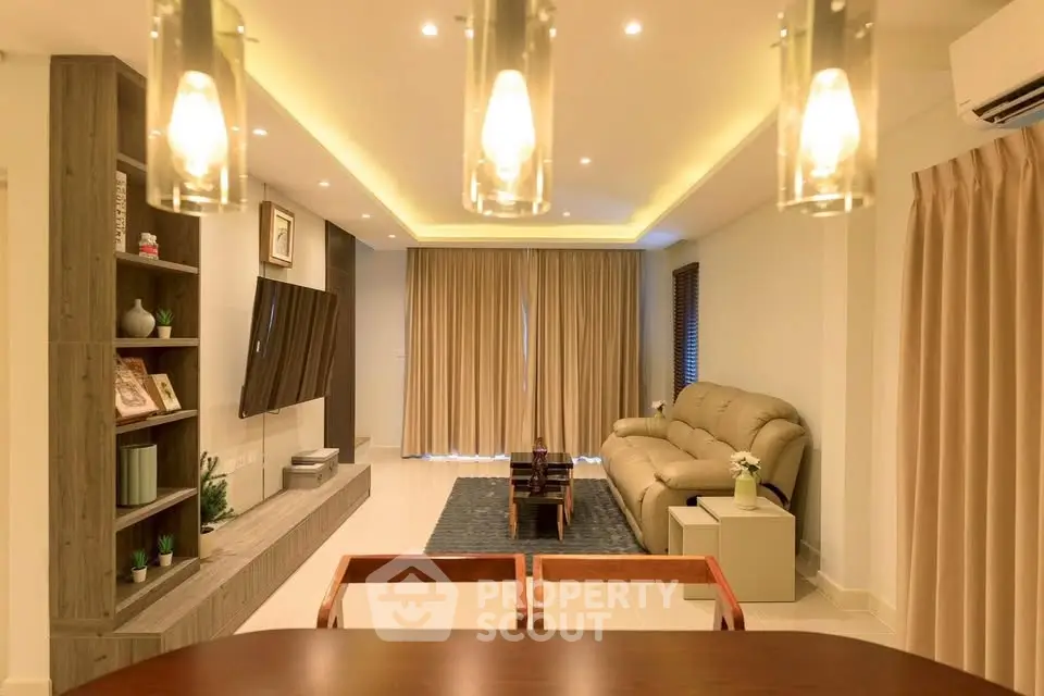 Luxurious modern living room with elegant lighting and cozy seating area.