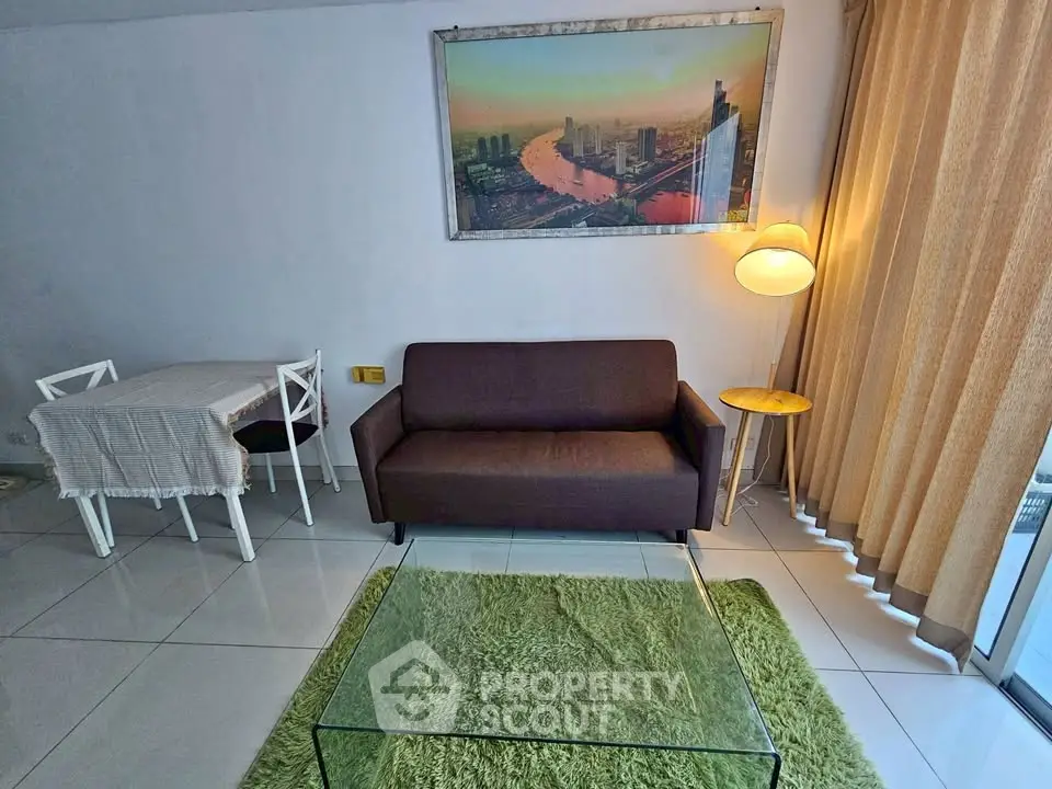 Modern living room with stylish sofa, glass coffee table, and cityscape artwork.