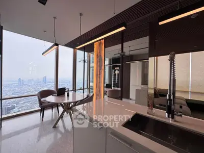 Luxurious modern kitchen with panoramic city view and sleek design.