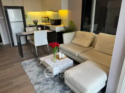 Modern living room with cozy sofa and stylish kitchen in open layout