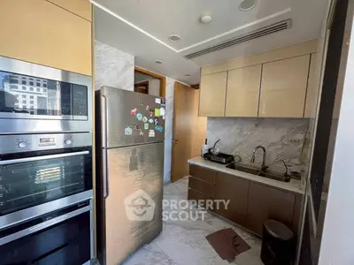 Modern kitchen with stainless steel appliances and marble flooring