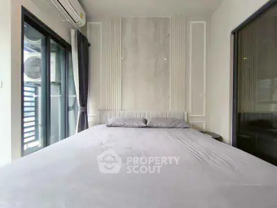 Modern bedroom with large window and minimalist decor