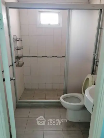 Compact bathroom with shower and modern fixtures in a cozy real estate property.