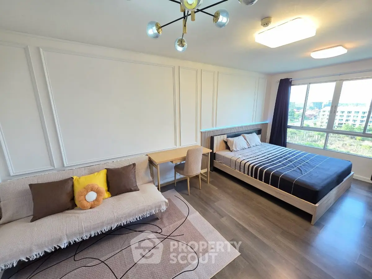 Spacious modern bedroom with stylish decor and large window view