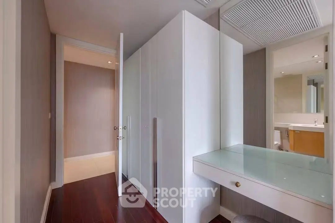 Sleek modern hallway with elegant built-in storage and stylish vanity area.