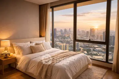 Luxurious bedroom with stunning city skyline view at sunset, featuring elegant decor and large windows.