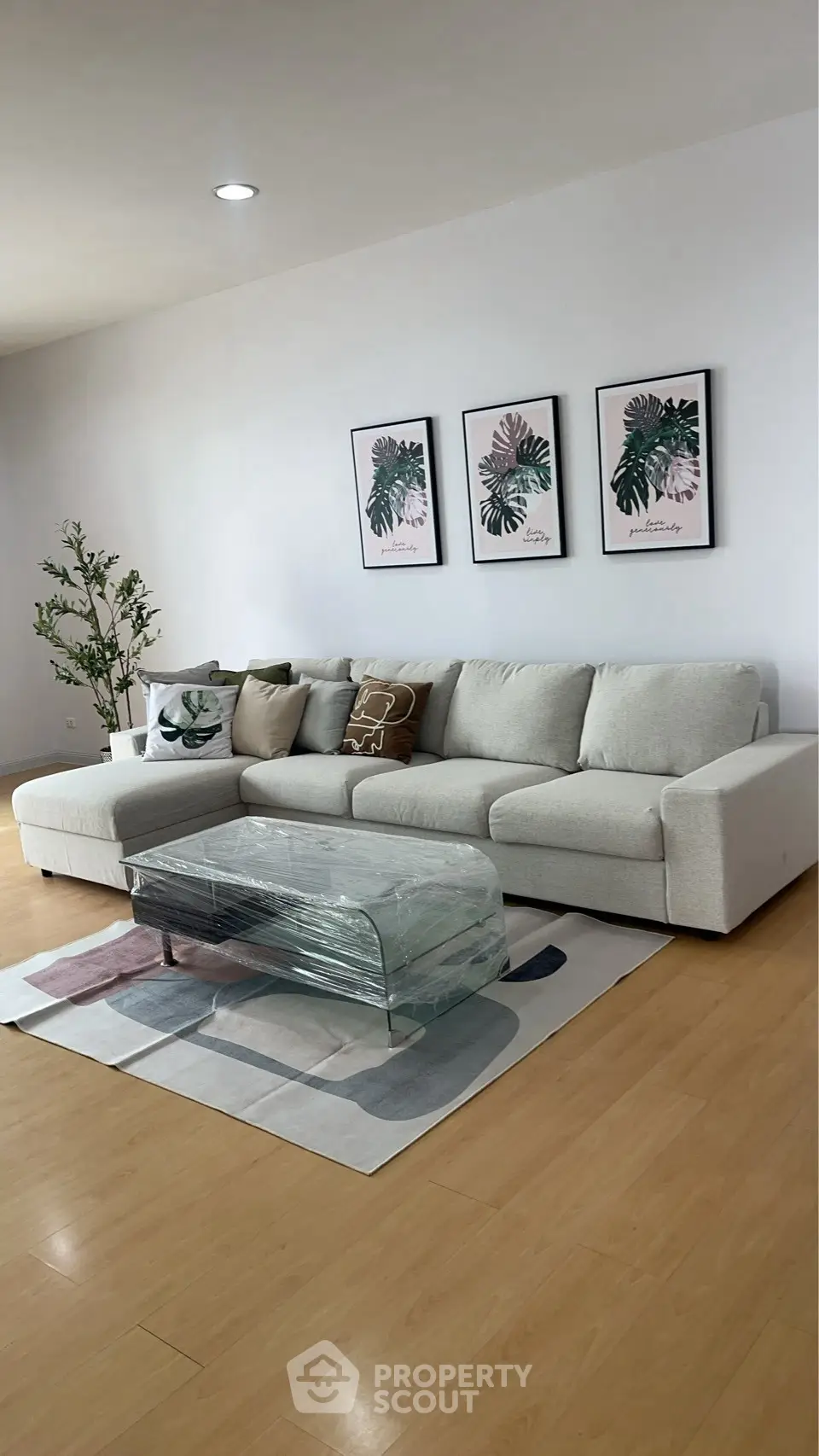 Spacious living room with modern decor and stylish glass coffee table.