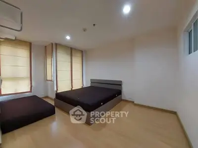 Spacious bedroom with modern design and ample natural light