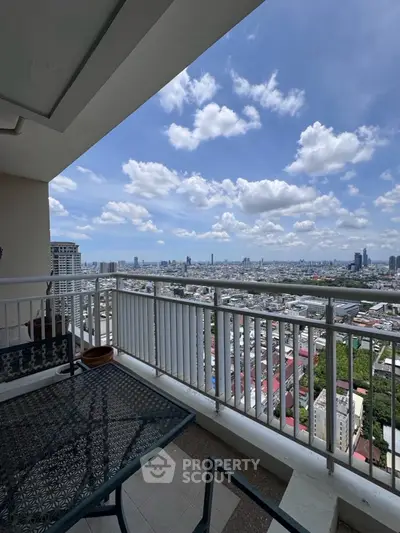 Stunning balcony view of city skyline with clear blue skies and modern railing.