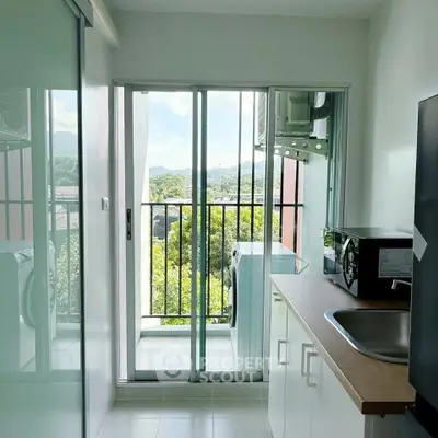 Modern kitchen with balcony view and sleek appliances